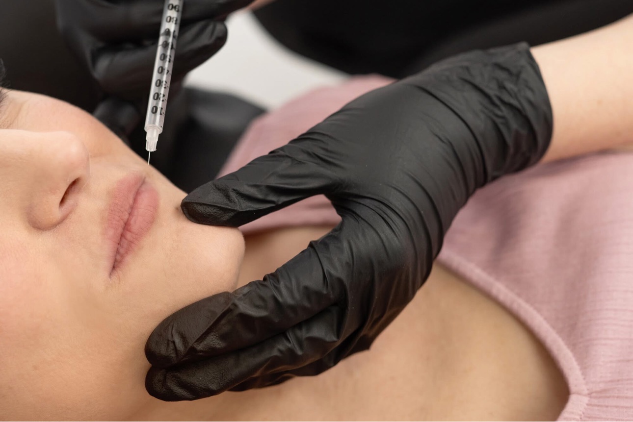 Sarah Jones, FNP-BC, performing a lip filler treatment at Glow Medical Group