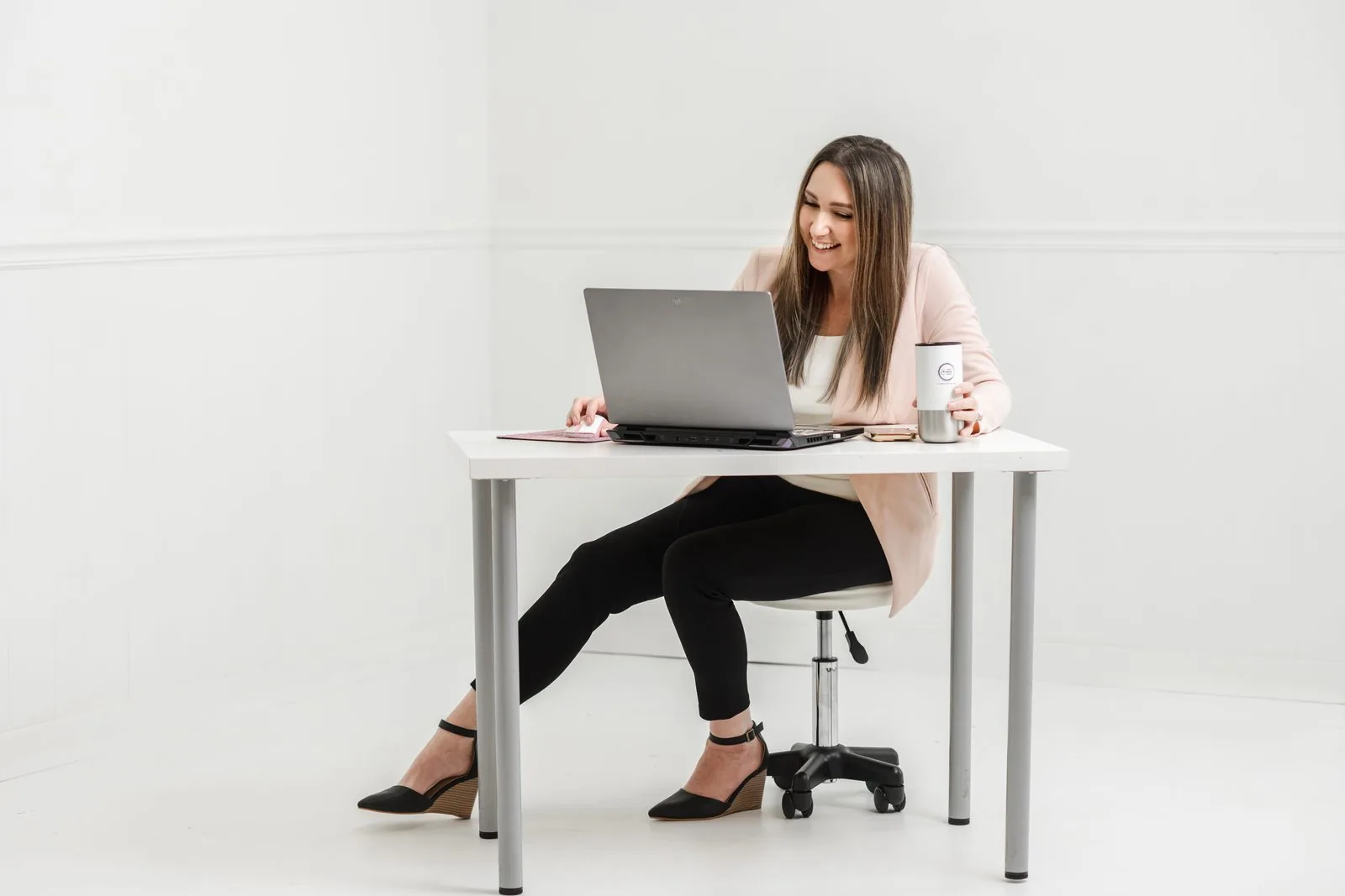 Sarah Jones, FNP-BC working at her desk